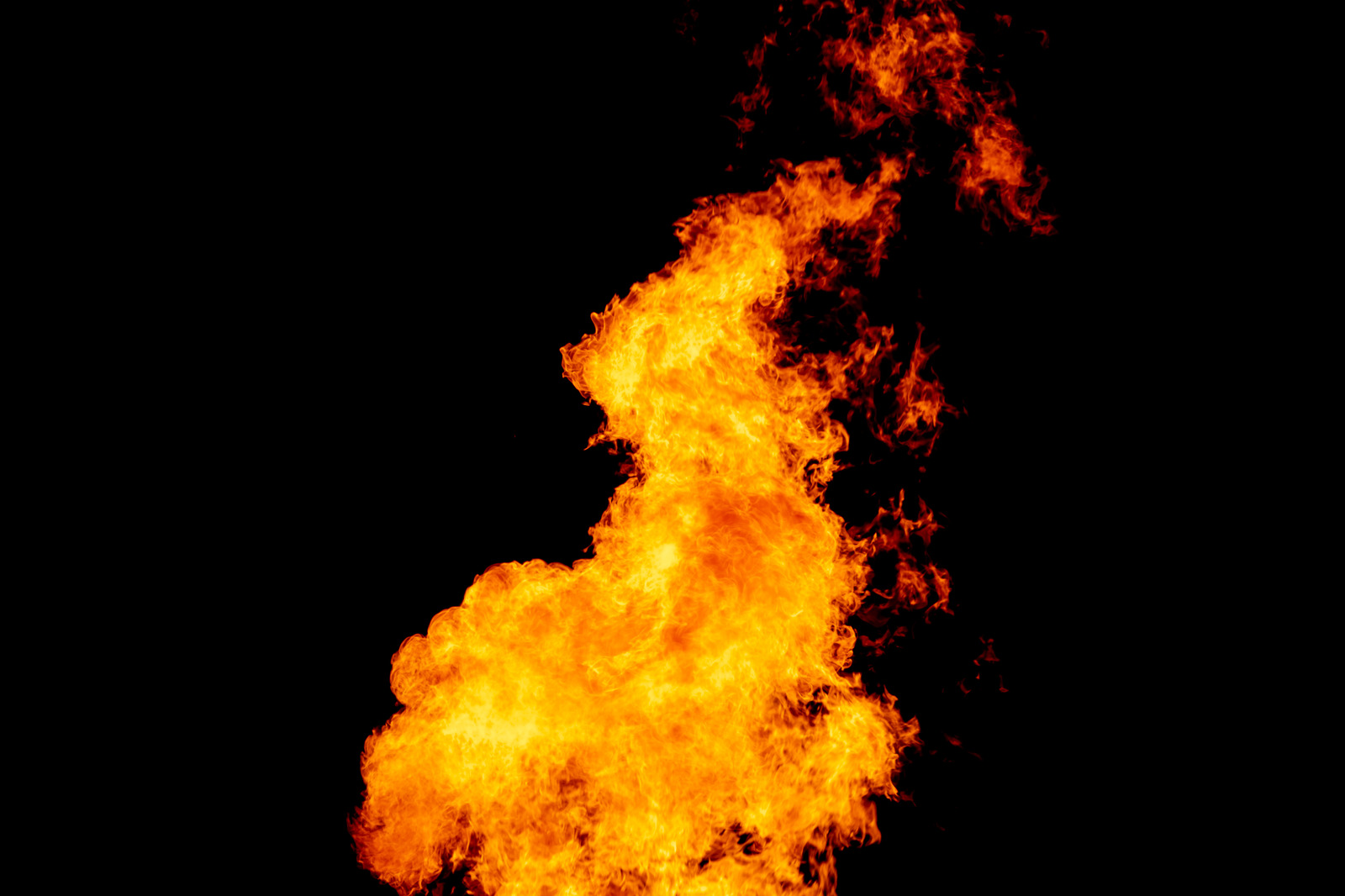 Yellow red and orange fire flames blazing fiery burning isolated on a black background
